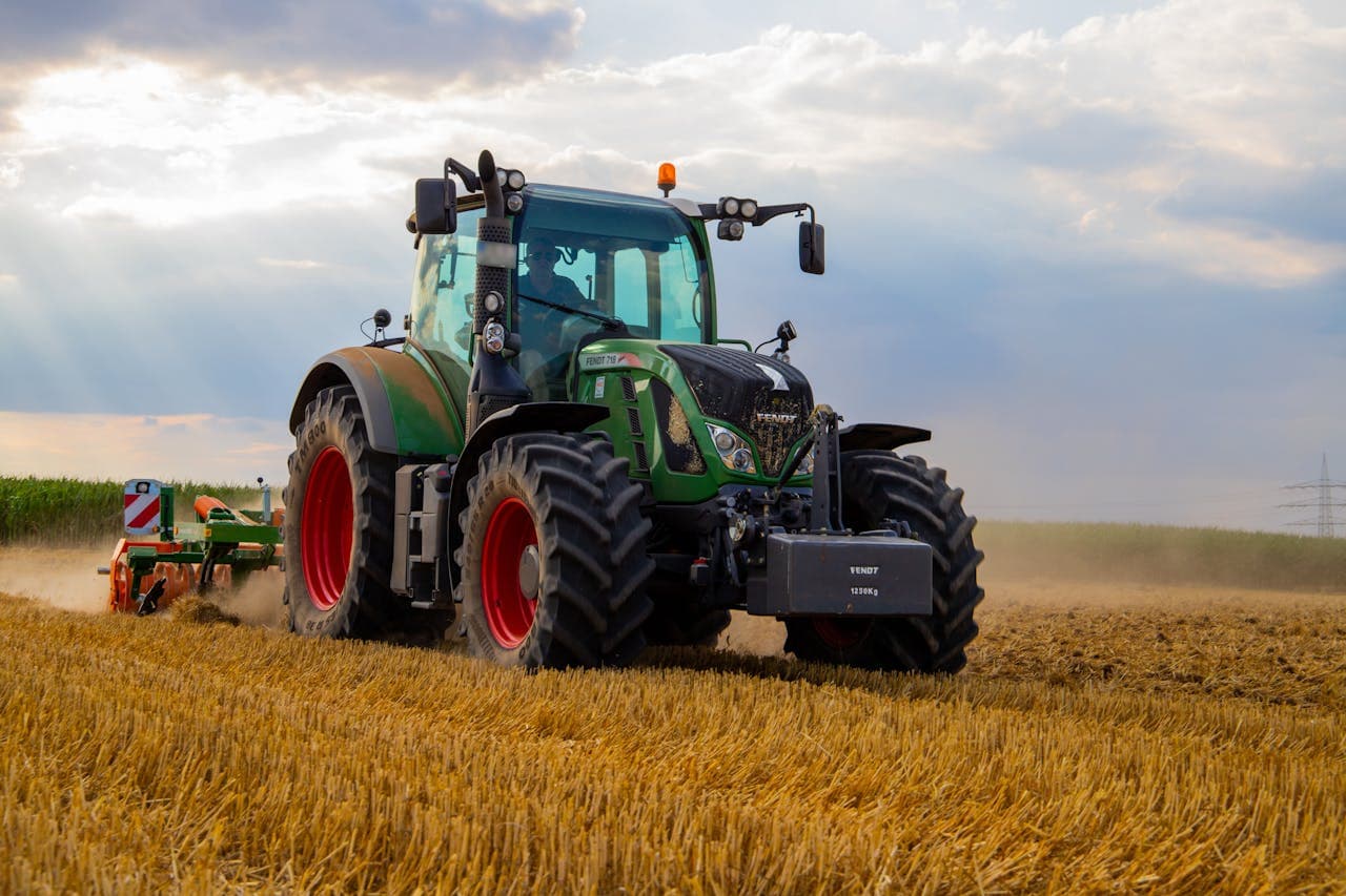 Compact tractor working on a small farm property, representing typical used tractor pricing for hobby farms and small acreage in 2026