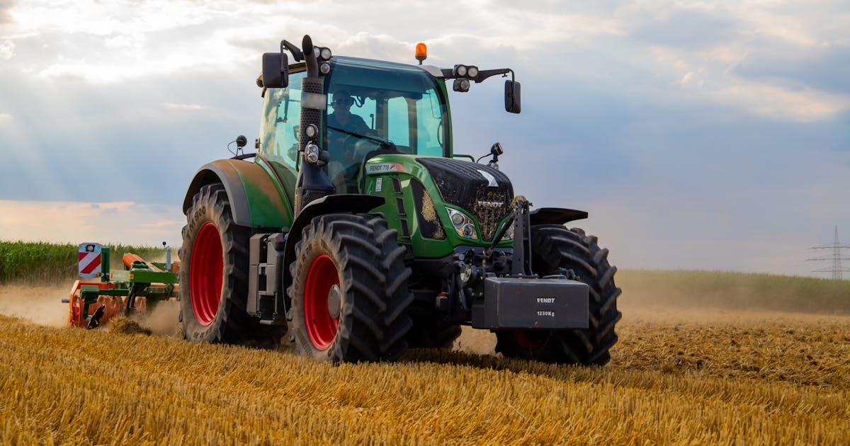 Used farm tractor staged for sale in a clean field, illustrating how to sell farm equipment fast