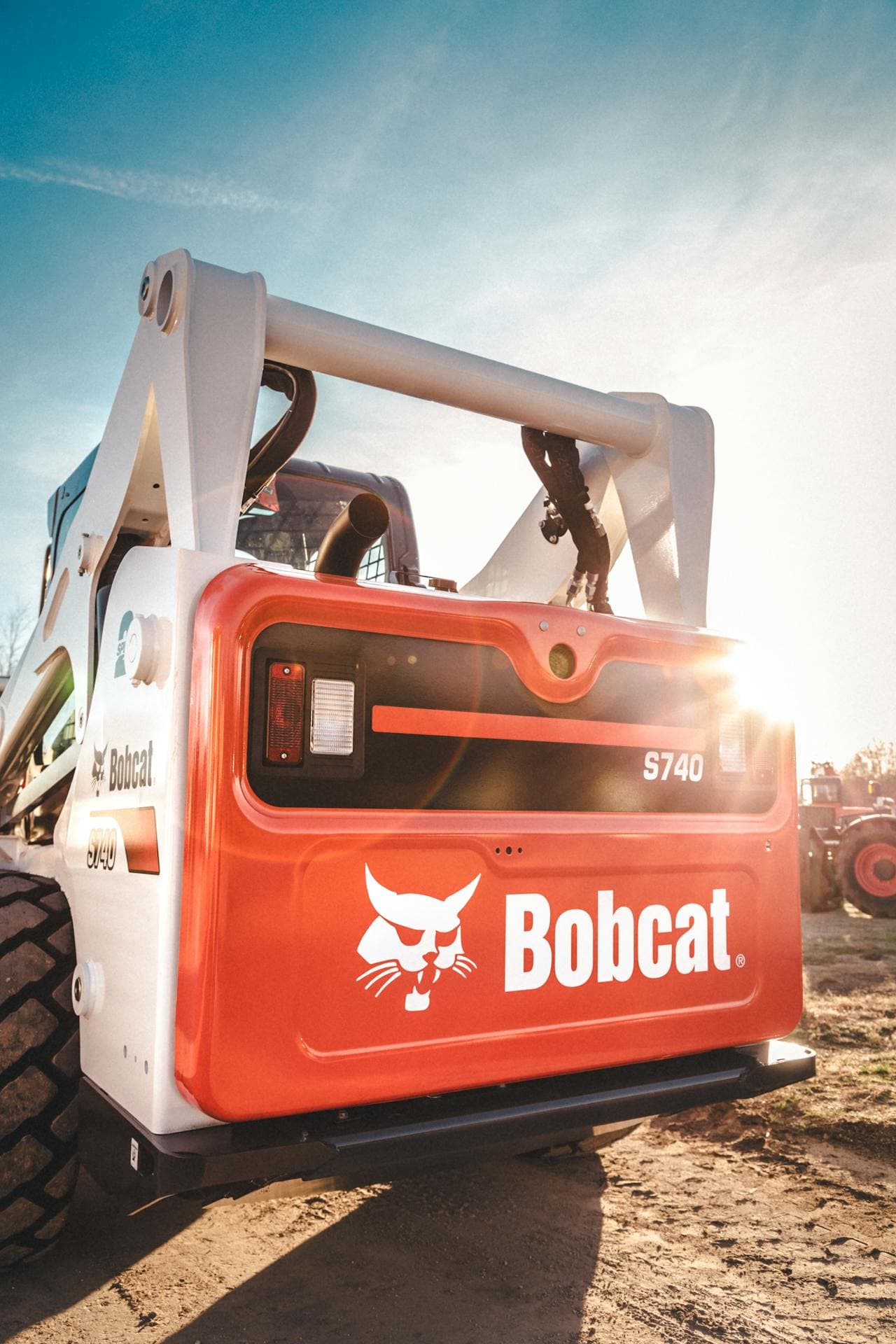 Skid steer loader working on a construction site, illustrating loader type comparison for equipment buyers