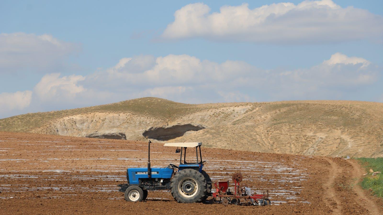 Modern tractor running a field pass, illustrating the 2026 autonomous tractor market for self-driving farming equipment